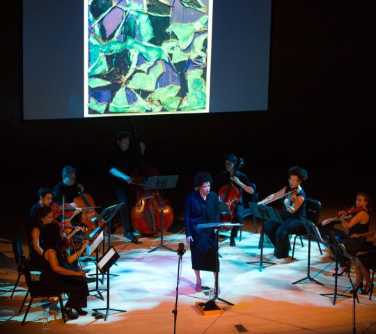 Julia Bullock sings in front of a small orchestra for her History's Persistent Voice program at the Metropolitan Museum of Art.