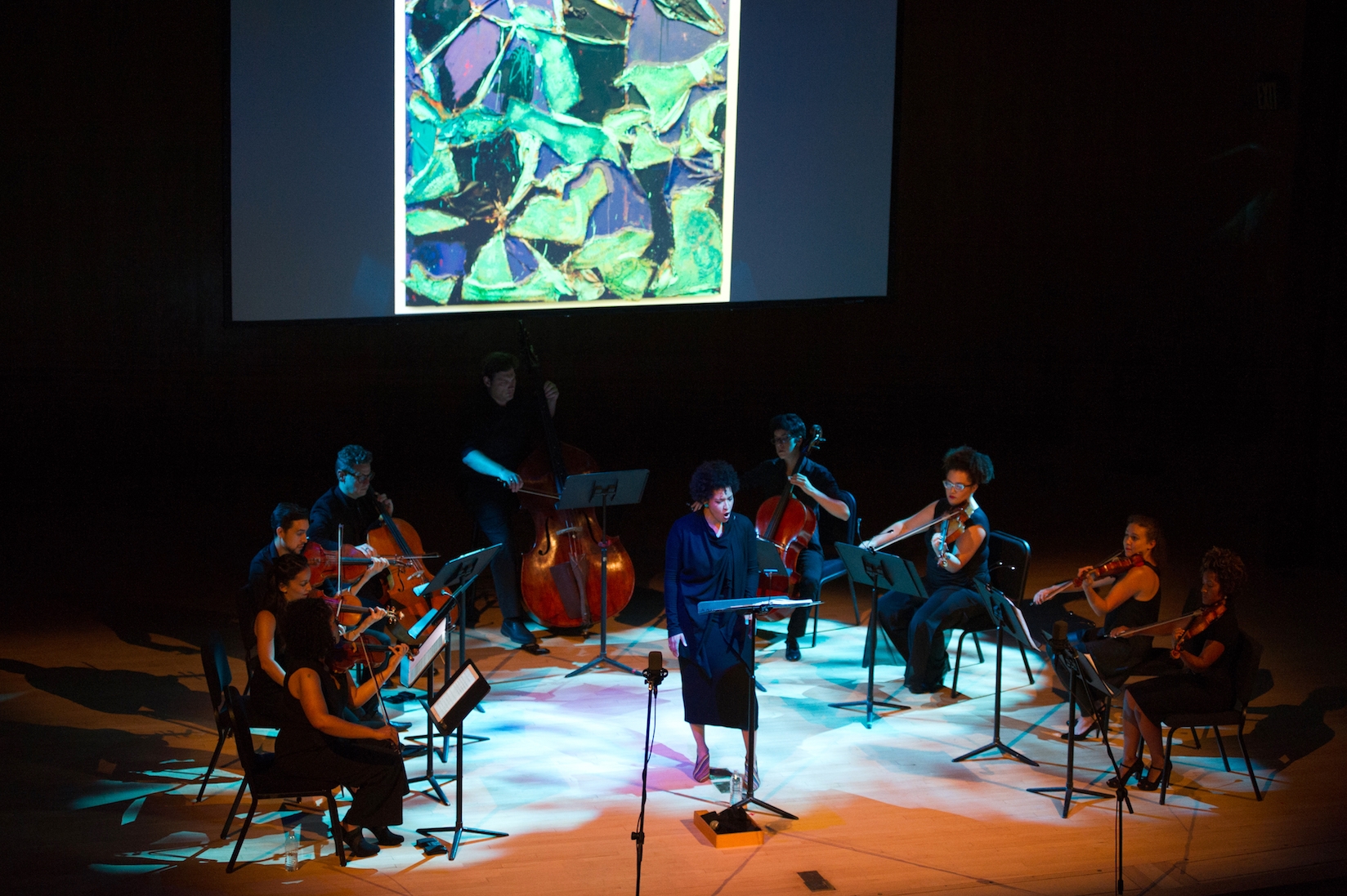 Julia Bullock sings in front of a small orchestra for her History's Persistent Voice program at the Metropolitan Museum of Art.