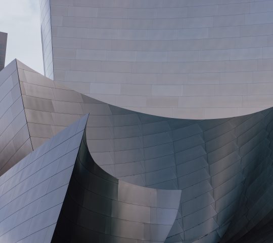 An outside view of Walt Disney Concert Hall in Los Angeles featuring curved steel edges.