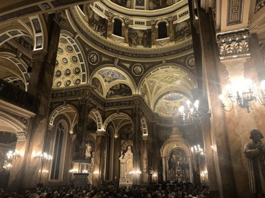 The Basilica of St. Josaphat in Milwaukee, Wisconsin which has high, domed ceilings with geometric designs and paintings.